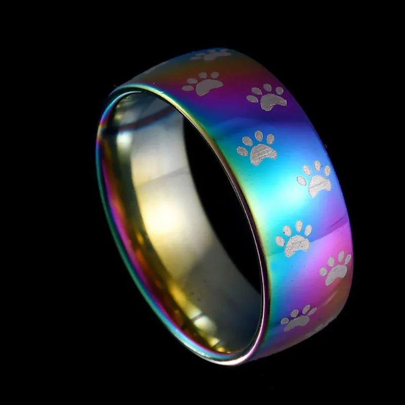 Handcrafted rainbow-coloured stainless steel ring with paw print.